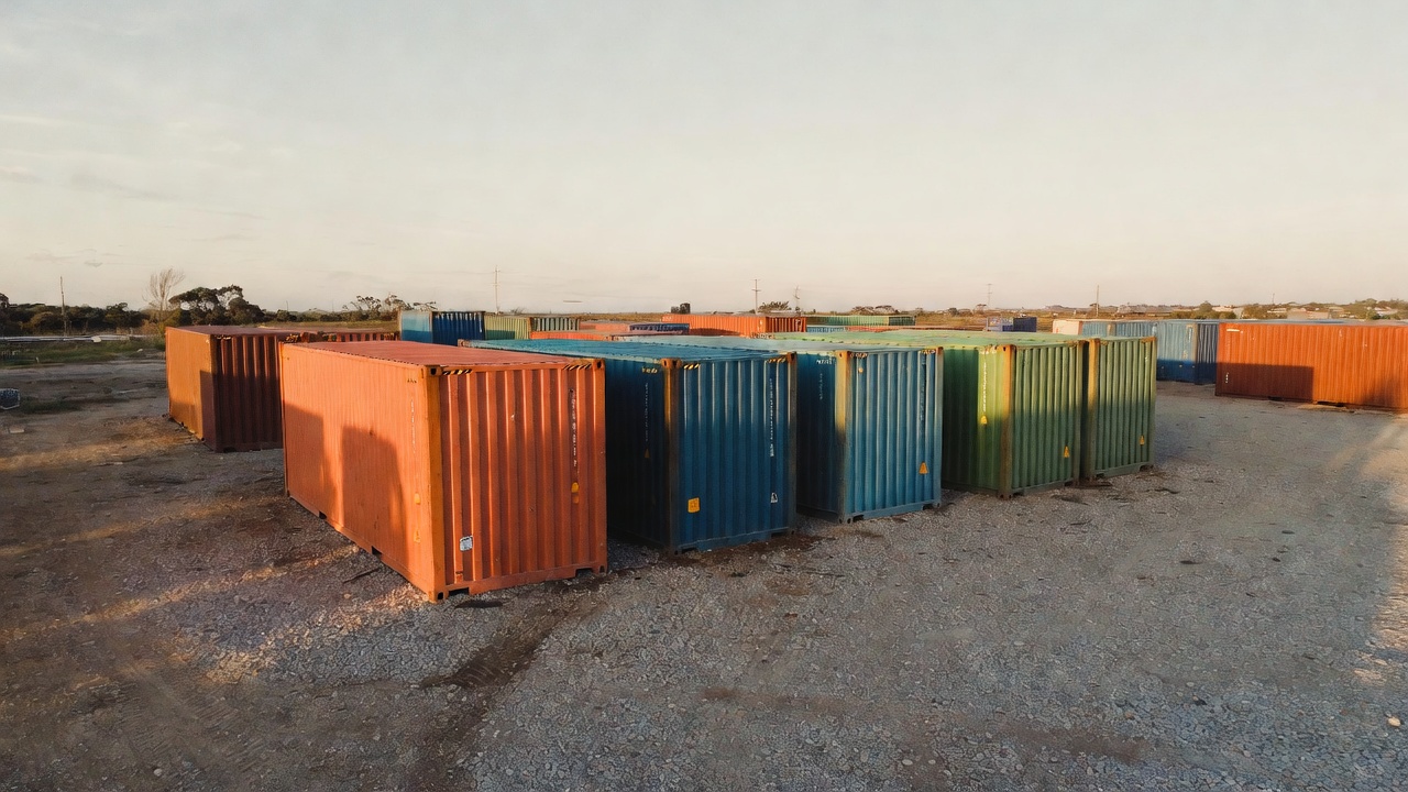 Colorful shipping containers at a depot at golden hour