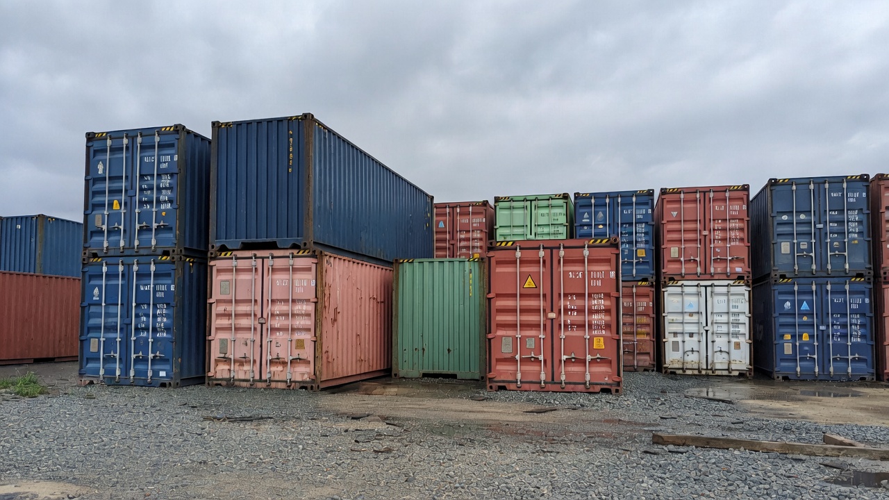 Stacked shipping containers at a rental depot